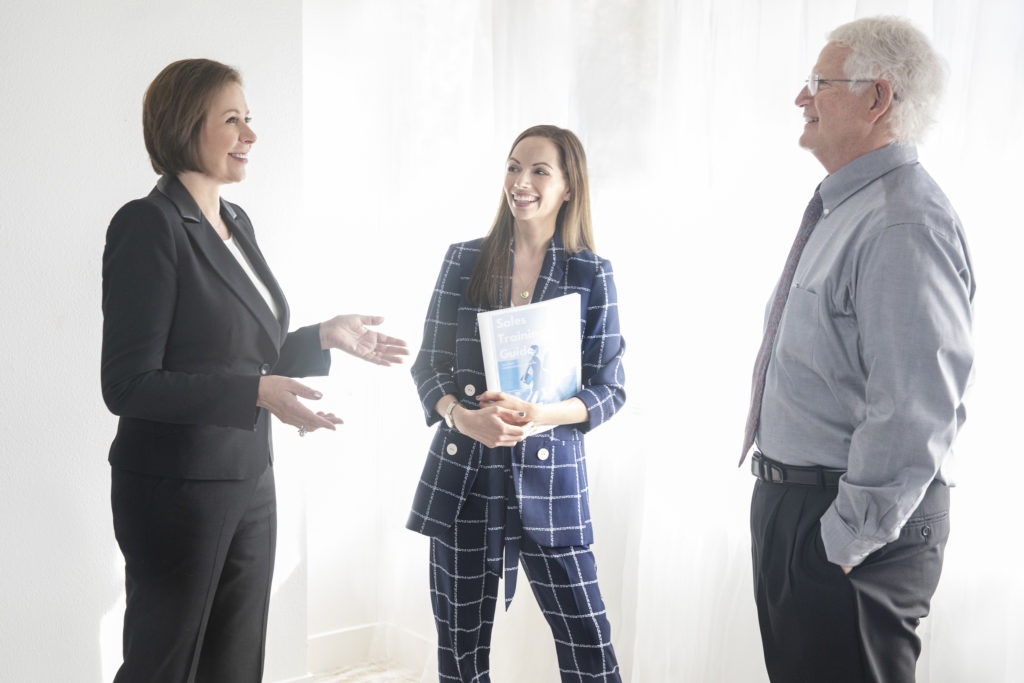 LaNell, Maria, and executive casually talking