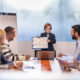 Young business boy showing the team reports in meeting