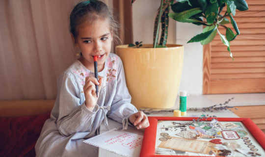 Little girl creating vision board