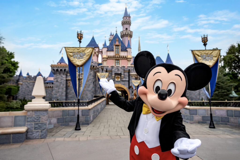 Mickey Mouse in front of the Disney castle.