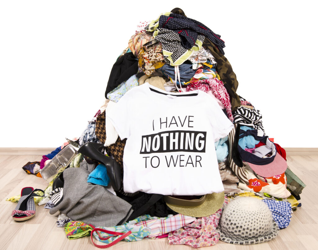 Shirt that says, "I have nothing to wear" sitting on top of a pile of laundry