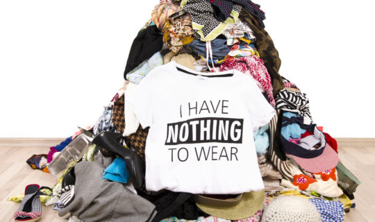 Shirt that says, "I have nothing to wear" sitting on top of a pile of laundry